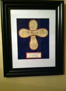 Under the cross it says: "EVERYONE COMMITS ERRORS, BUT HIS SACRIFICE WILL GET YOU HOME..."